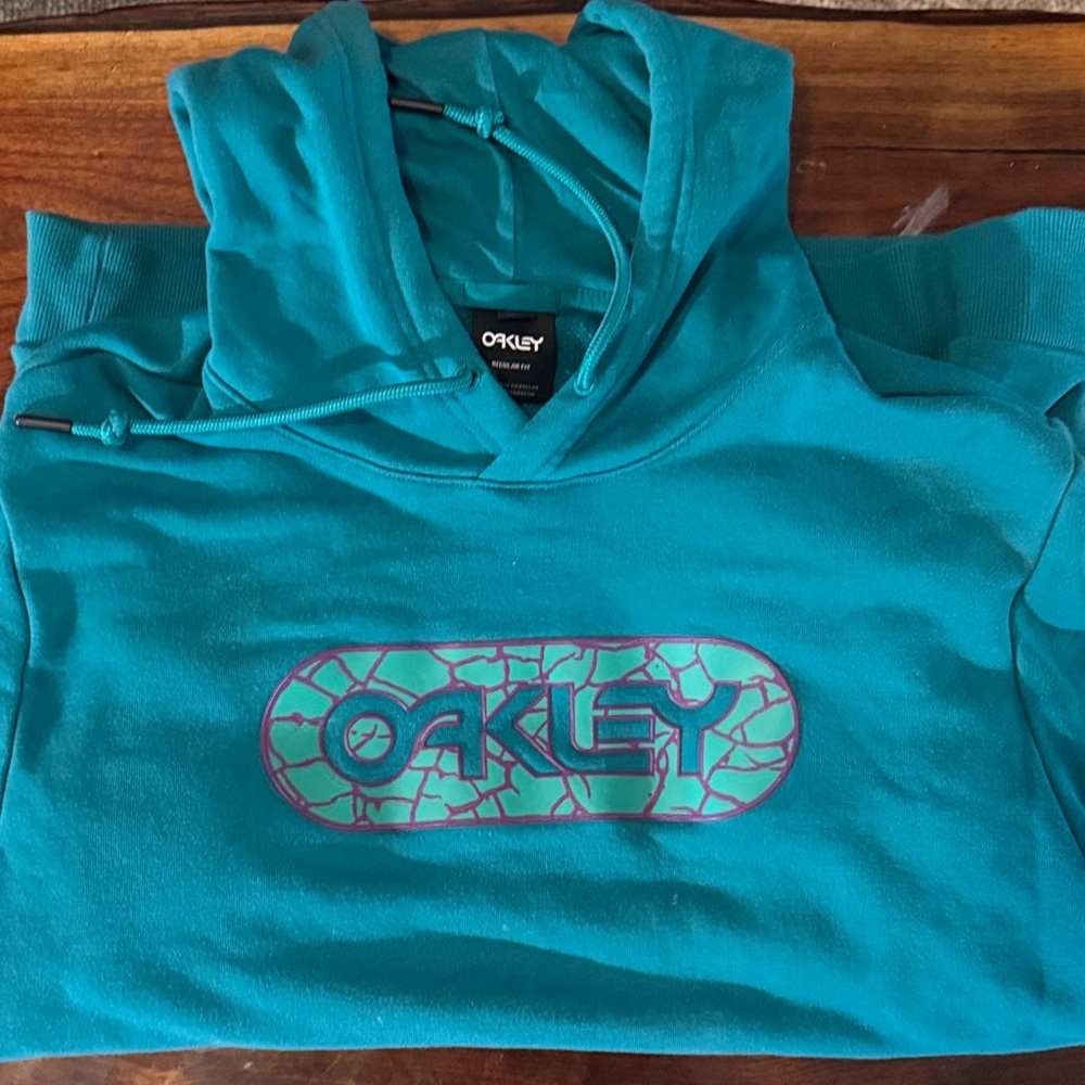 Oakley Turquoise Hoodie with Purple Logo
